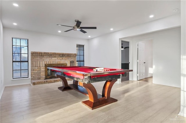 game room featuring a fireplace, recessed lighting, light wood-style floors, and a ceiling fan