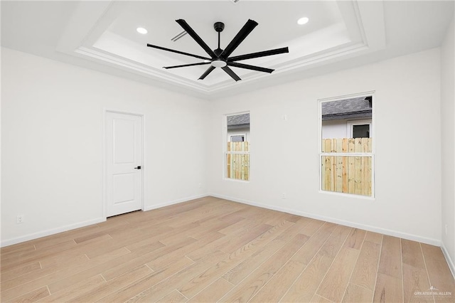 1003 Bette St, Pharr, TX 78577 - empty room with baseboards, a ceiling fan, light wood-style floors, and a raised ceiling