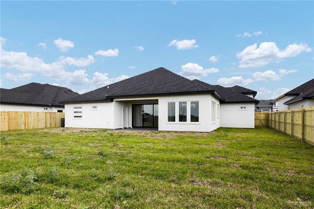 1003 Bette St, Pharr, TX 78577 - rear view of house featuring a lawn, a fenced backyard, and stucco siding
