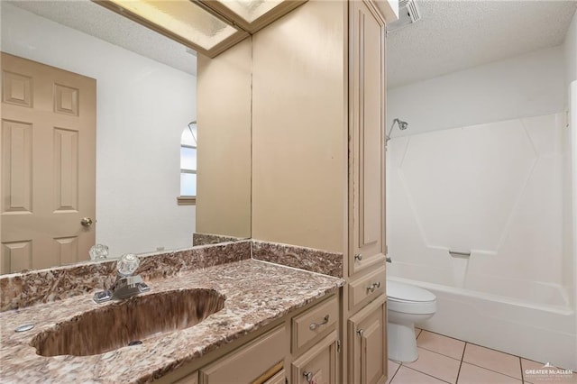 full bathroom with washtub / shower combination, tile patterned flooring, vanity, a textured ceiling, and toilet