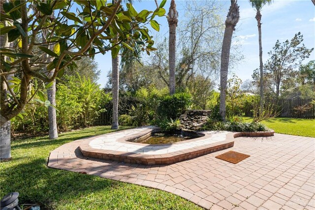 surrounding community featuring a yard, fence, and a patio