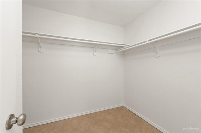 spacious closet featuring tile patterned flooring