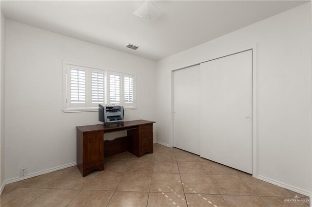 office space with visible vents, baseboards, and light tile patterned flooring