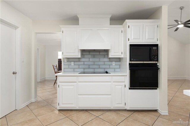 kitchen with custom exhaust hood, light countertops, black appliances, white cabinetry, and light tile patterned flooring