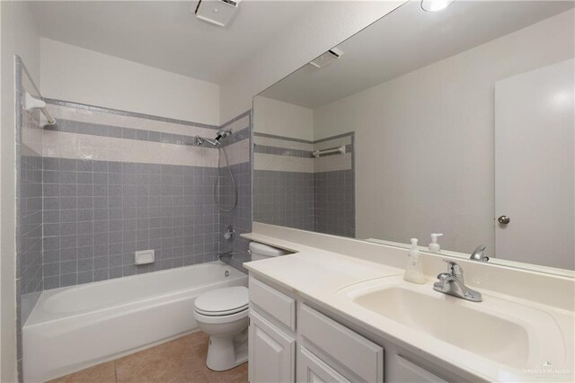 bathroom featuring toilet, tile patterned flooring,  shower combination, and vanity