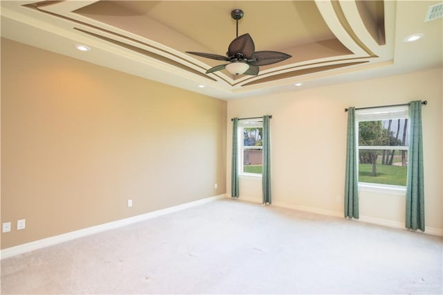 1018 Buena Suerte, Weslaco, TX 78596 - unfurnished room featuring a tray ceiling, light carpet, and a healthy amount of sunlight