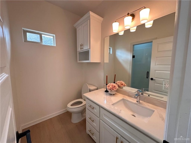 bathroom with hardwood / wood-style flooring, vanity, and toilet