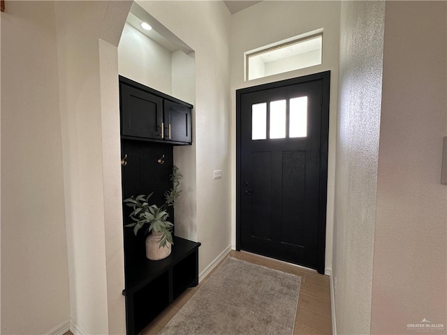 foyer entrance with light tile patterned flooring