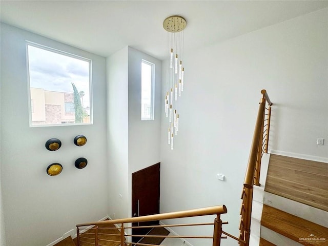 stairway featuring wood finished floors and baseboards