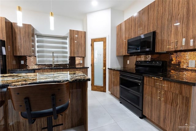 kitchen featuring dark stone counters, black appliances, decorative backsplash, light tile patterned floors, and modern cabinets