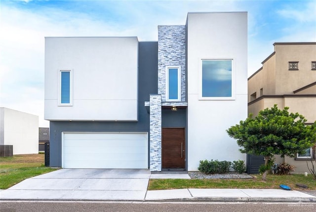 contemporary home featuring an attached garage, stone siding, concrete driveway, and stucco siding