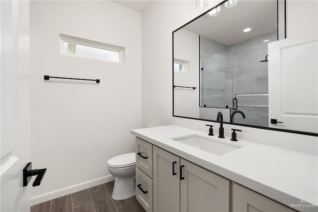 904 N Trinity St, Edinburg, TX 78541 - full bath featuring vanity, plenty of natural light, a marble finish shower, and wood finished floors