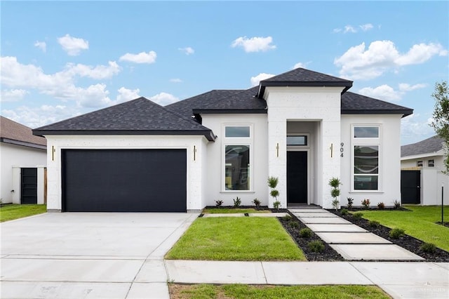 904 N Trinity St, Edinburg, TX 78541 - view of front of home featuring an attached garage, a shingled roof, concrete driveway, and stucco siding