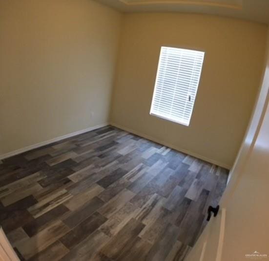 empty room featuring dark wood-type flooring