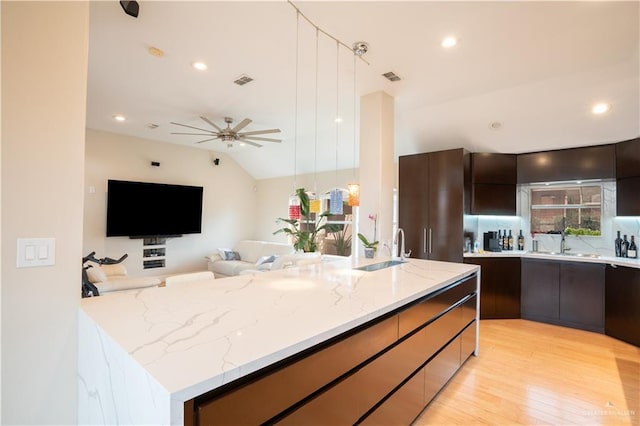 kitchen with visible vents, modern cabinets, and a sink