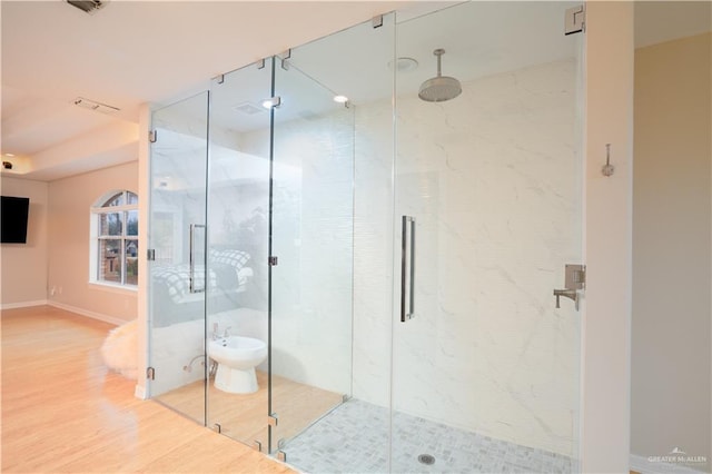 full bathroom featuring visible vents, a stall shower, baseboards, and wood finished floors