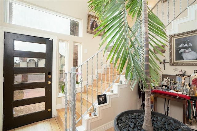 entrance foyer with stairway and wood finished floors