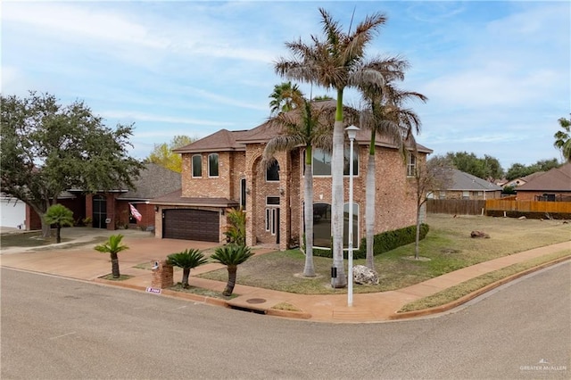 view of front of property featuring brick siding, concrete driveway, an attached garage, and fence