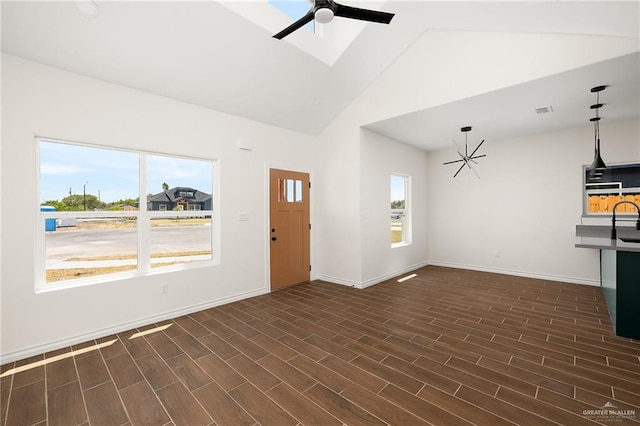 unfurnished living room featuring high vaulted ceiling and ceiling fan