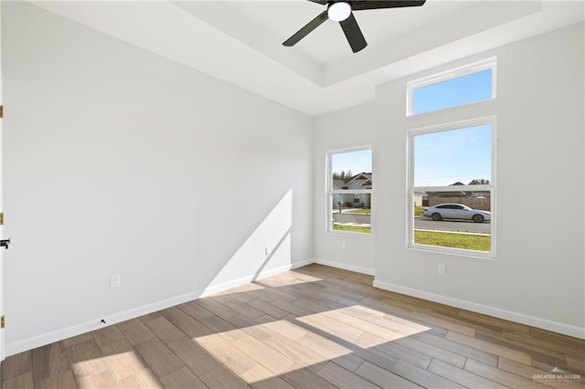 700 Juan Seguin St, Weslaco, TX 78599 - spare room with a raised ceiling, wood finished floors, and baseboards