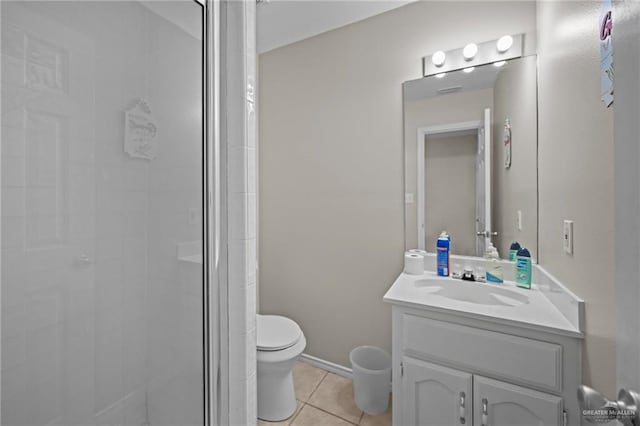 bathroom with tile patterned floors, vanity, toilet, and a shower with shower door