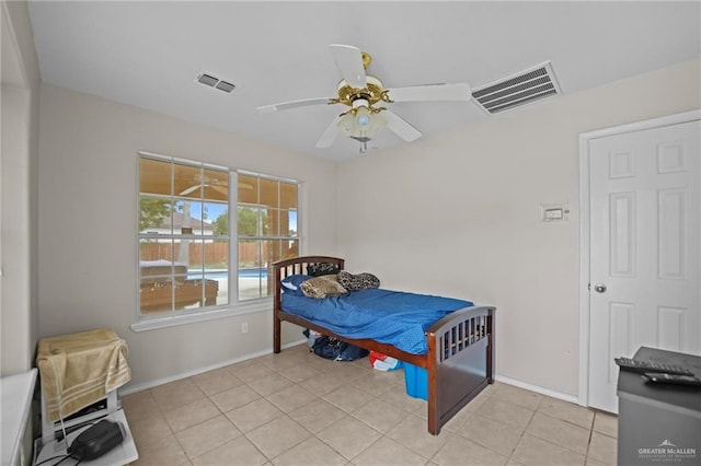 tiled bedroom featuring ceiling fan