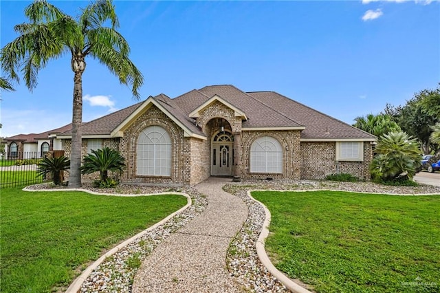 single story home with a front yard and a garage