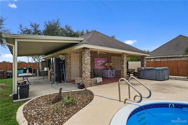 exterior space featuring a patio and a hot tub