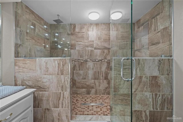 bathroom featuring vanity and an enclosed shower