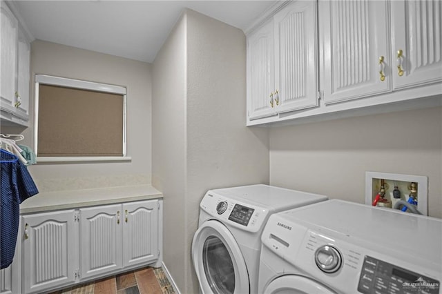 laundry area featuring cabinets, dark hardwood / wood-style flooring, and washing machine and dryer