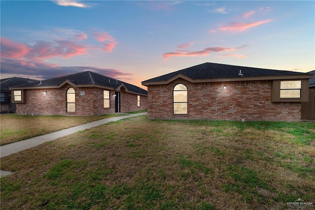 ranch-style house with a lawn