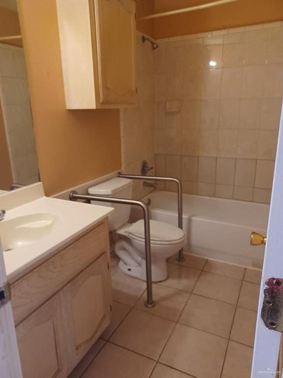 full bathroom featuring tile patterned flooring, tiled shower / bath combo, toilet, and vanity