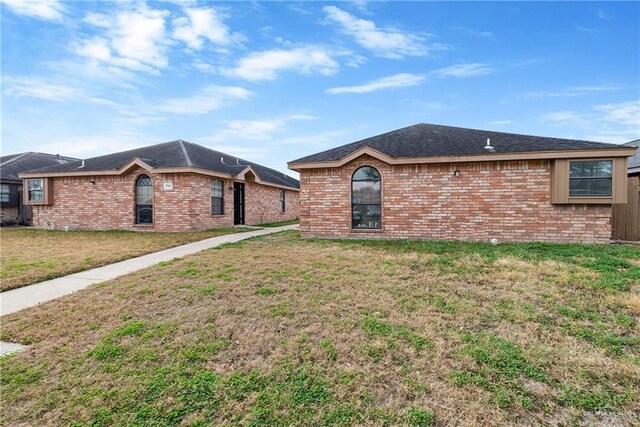 view of side of property with a yard