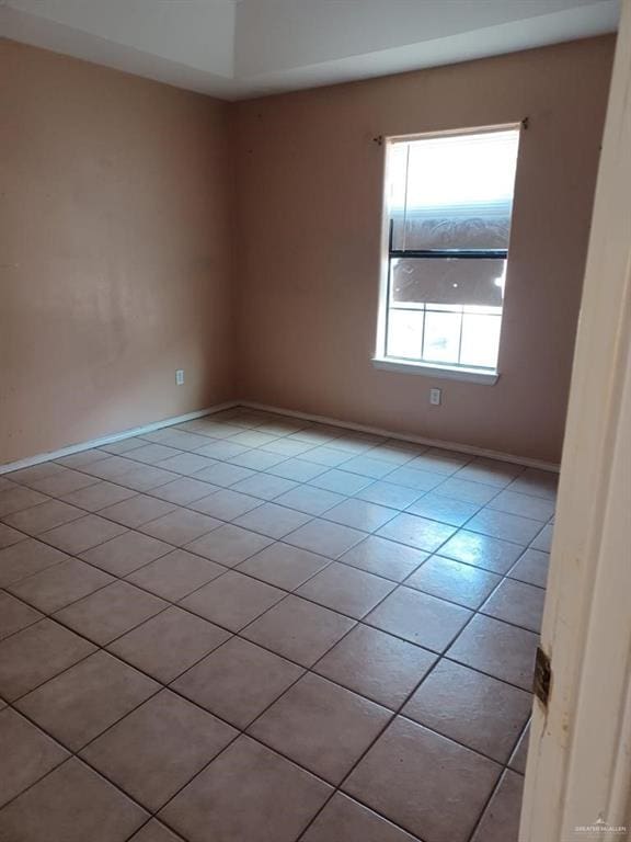 unfurnished room featuring light tile patterned floors