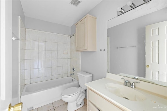 full bathroom with vanity, tiled shower / bath, tile patterned floors, and toilet