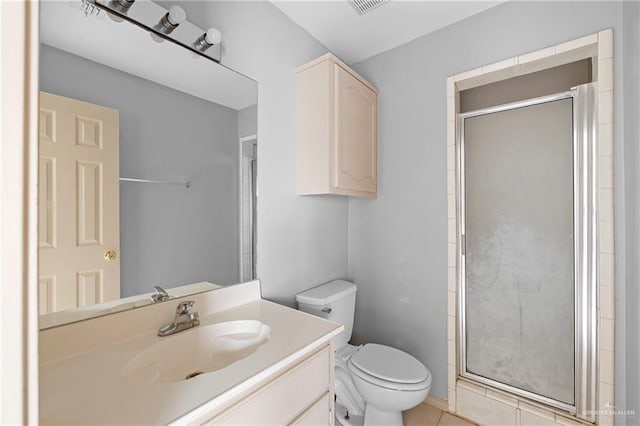 bathroom featuring tile patterned flooring, vanity, an enclosed shower, and toilet