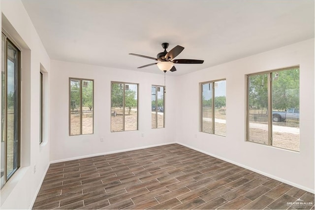 unfurnished sunroom featuring ceiling fan