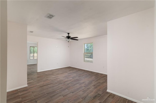 spare room with ceiling fan and dark hardwood / wood-style flooring