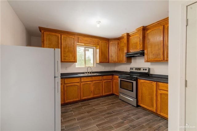 kitchen featuring white refrigerator, stainless steel electric stove, and sink