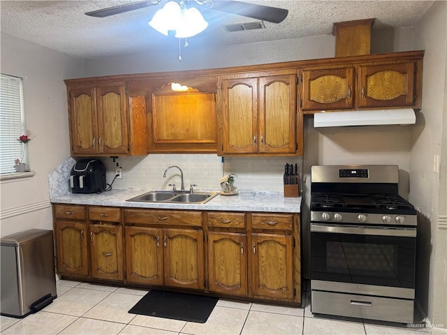 1008 S 3rd St, Edinburg, TX 78539 - kitchen with gas stove, range hood, a ceiling fan, light countertops, and a textured ceiling