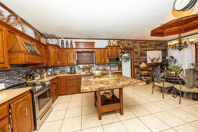 kitchen featuring an inviting chandelier, ornamental molding, light tile patterned floors, tasteful backsplash, and stainless steel appliances