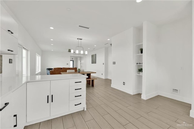 2208 Providence Ave, Mcallen, TX 78504 - kitchen featuring a peninsula, white cabinetry, recessed lighting, open floor plan, and light countertops
