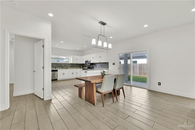 2208 Providence Ave, Mcallen, TX 78504 - kitchen with white cabinetry, stainless steel appliances, light wood-type flooring, a chandelier, and recessed lighting