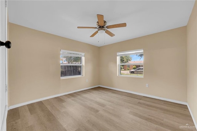 209 E 11th St, San Juan, TX 78589 - spare room featuring light wood finished floors, a ceiling fan, and baseboards