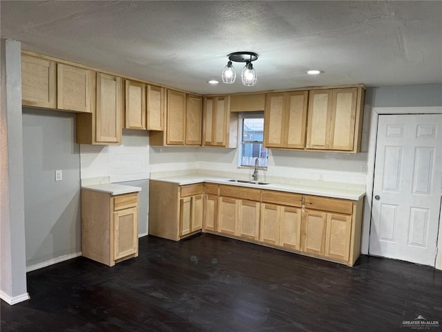 kitchen featuring a textured ceiling, light brown cabinetry, sink, and dark hardwood / wood-style floors