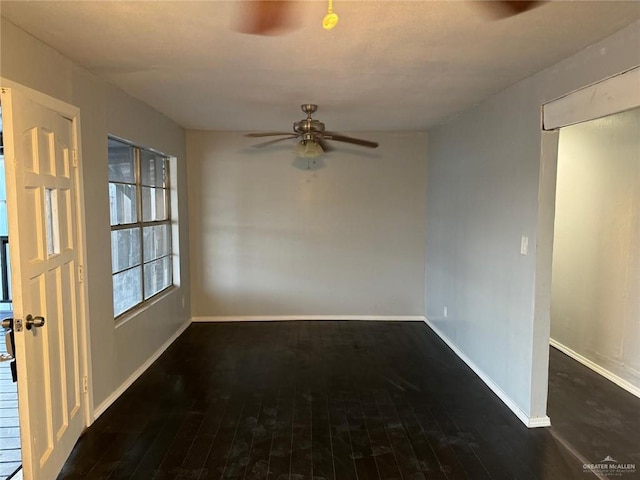 unfurnished room with ceiling fan and dark hardwood / wood-style floors