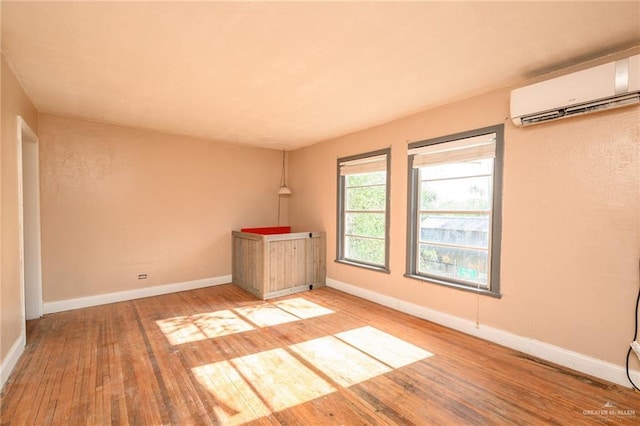 408 E Ebony St, La Feria, TX 78559 - spare room featuring hardwood / wood-style floors and a wall unit AC