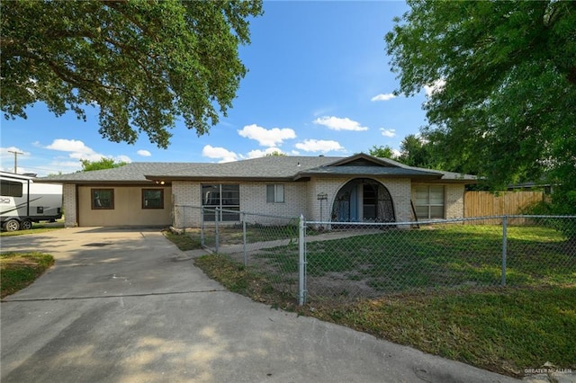 408 E Ebony St, La Feria, TX 78559 - ranch-style home featuring brick siding, driveway, and a fenced front yard