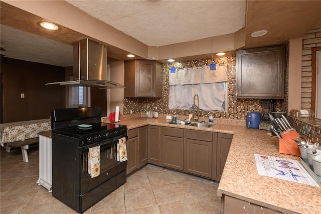 408 E Ebony St, La Feria, TX 78559 - kitchen with black range, exhaust hood, tasteful backsplash, light countertops, and light tile patterned floors