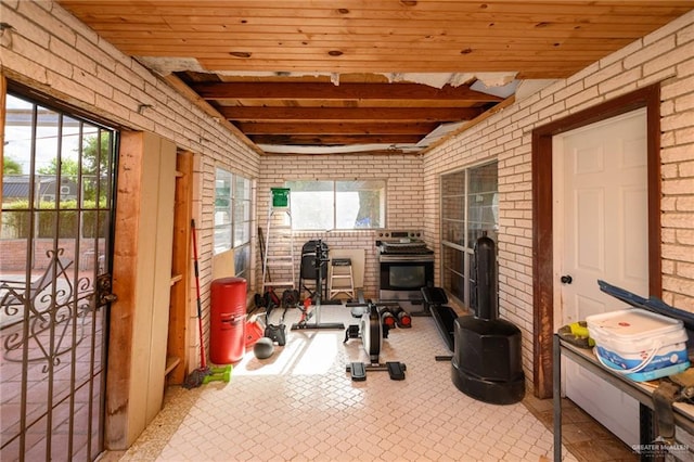 408 E Ebony St, La Feria, TX 78559 - exercise room with brick wall and wood ceiling